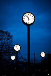 Low angle view of clock against sky at dusk