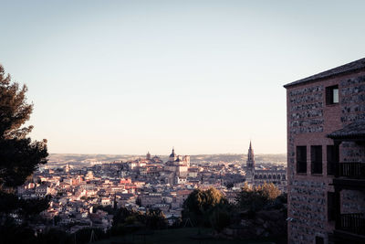 Buildings in city against clear sky