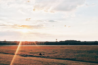 Scenic view of field against sky during sunset