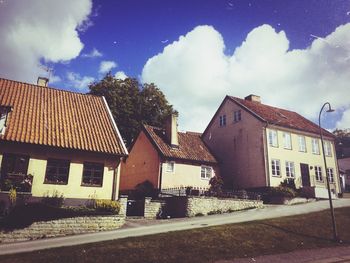 Buildings against cloudy sky