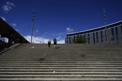 Low angle view of people walking on staircase