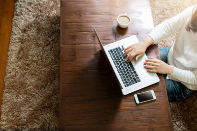 High angle view of man using laptop on table