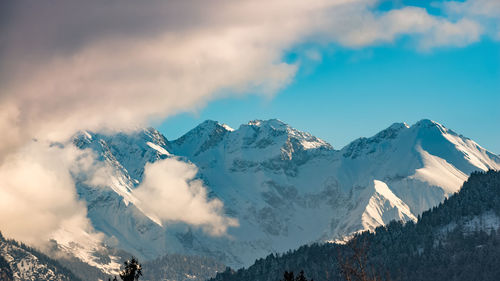 Scenic view of snowcapped mountains against sky