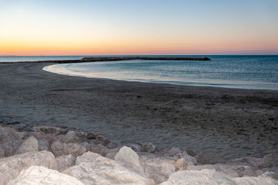 Scenic view of sea against clear sky during sunset