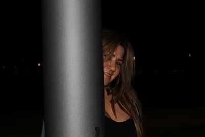 Close-up portrait of woman at night