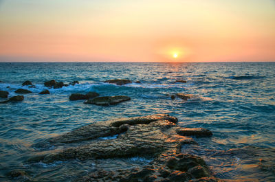 Scenic view of sea against sky during sunset