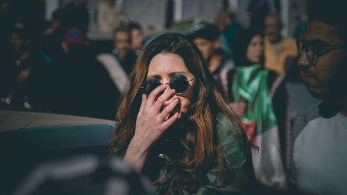 Portrait of young woman looking away outdoors