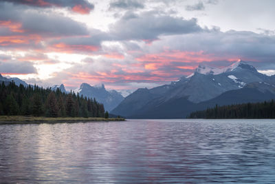 Purple sunrise on the bank of alpine lake with mountains in the background, jasper n.park, canada