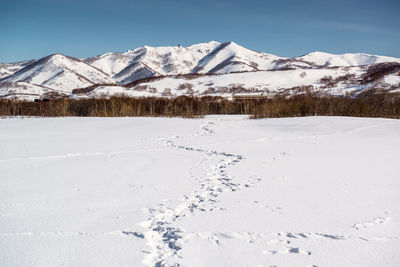 Scenic view of snowcapped mountains against sky