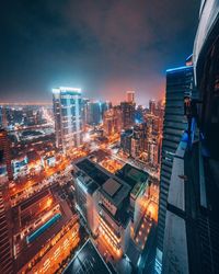 High angle view of illuminated buildings against sky at night