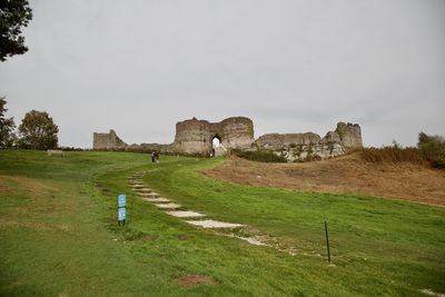 Built structure on field against sky