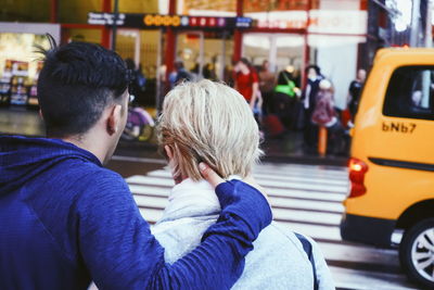 Rear view of couple walking in car