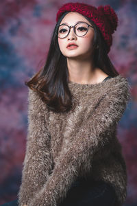 Portrait of a beautiful young woman standing outdoors