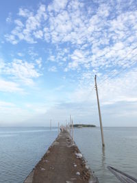 Jetty leading to calm sea