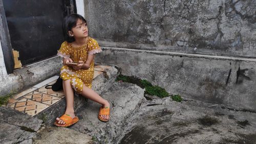 Young woman sitting on rock