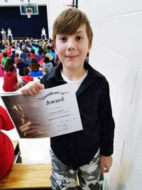 Portrait of boy standing on floor