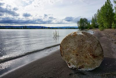 Scenic view of sea against sky with foam block
