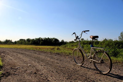 Bicycle on field against sky