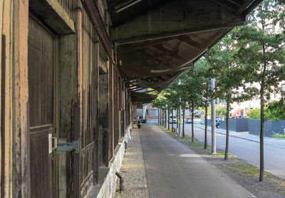 Empty road amidst buildings in city