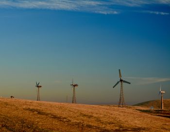 Windmill on field against sky