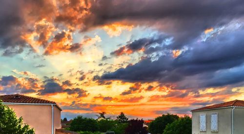 High section of house against cloudy sky at sunset