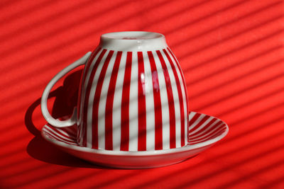 Close-up of red striped tea cup