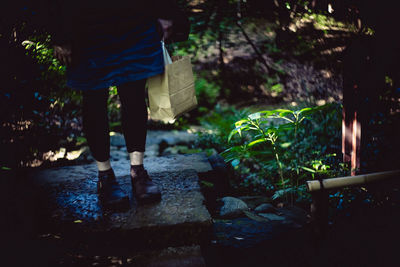 Low section of man standing on rock