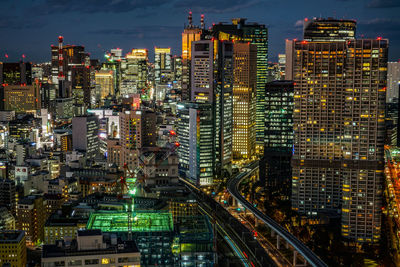 High angle view of illuminated buildings in city at night