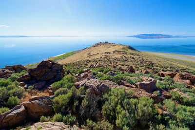 Scenic view of rocky mountains and sea against sky