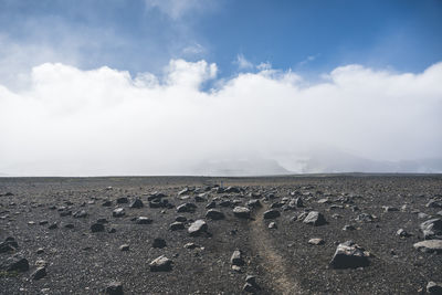 Rocky volcanic land on a cloudy day while hiking trail in iceland