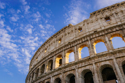 Low angle view of coliseum against sky