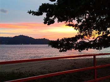 Scenic view of lake against orange sky