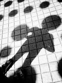 Shadow of people on tiled floor