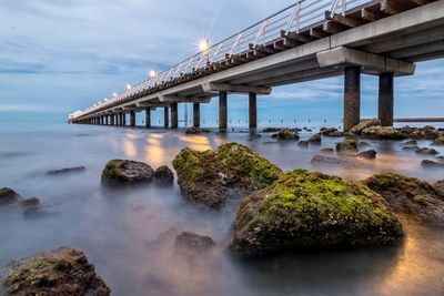 Bridge over sea against sky