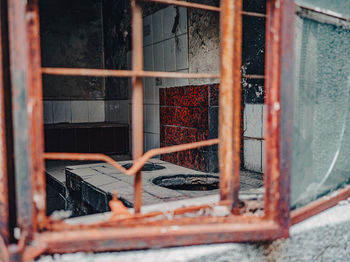 Close-up of broken glass window of abandoned building