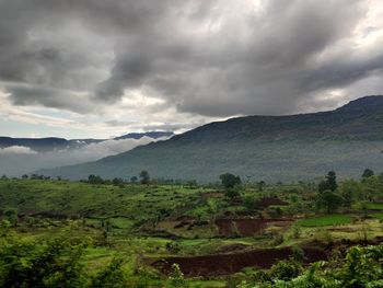 Scenic view of landscape and mountains against sky