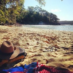 Low section of people relaxing on beach