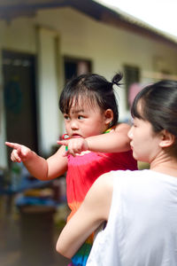 Mother carrying daughter