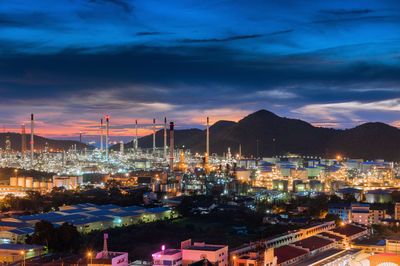 High angle view of illuminated cityscape against sky at night