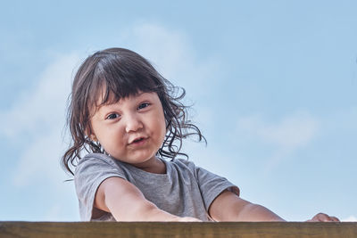 Portrait of cute girl against sky