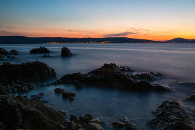 Scenic view of sea against sky at sunset