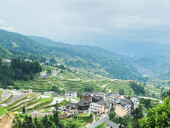 High angle view of houses and trees against sky