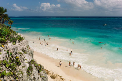 Scenic view of beach against cloudy sky