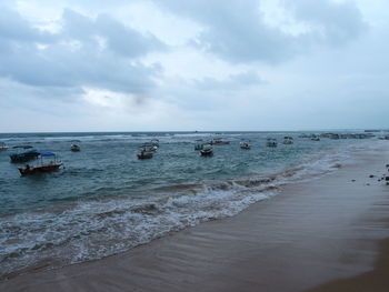 Scenic view of sea against cloudy sky