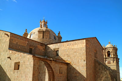 Low angle view of historic building against clear blue sky