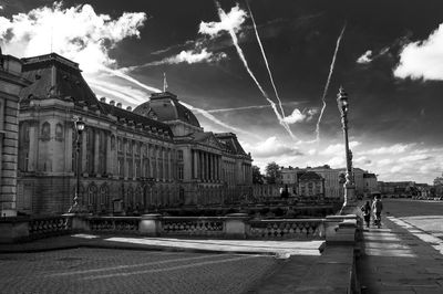 Buildings against cloudy sky