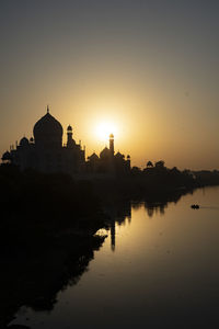 Taj mahal reflected in yamuna river at sunset in agra, india. 