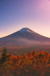 Scenic view of snowcapped mountain against sky during sunset