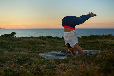 Inverted yoga pose of woman performing yoga