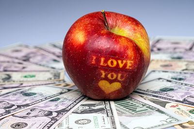 I love you apple with heart on dollar banknotes. the concept of love and prosperity. close-up